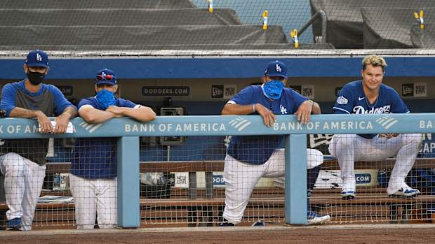 Jul 6, 2020; Los Angeles, California, United States; Los Angeles Dodgers right fielder Joc Pederson (far right) watches the action from the dugout during an intrasquad game at Dodger Stadium. Mandatory Credit: Robert Hanashiro-USA TODAY Sports